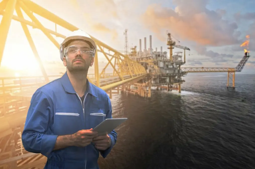 Oil and gas engineers using data analysis tools to optimize project efficiency