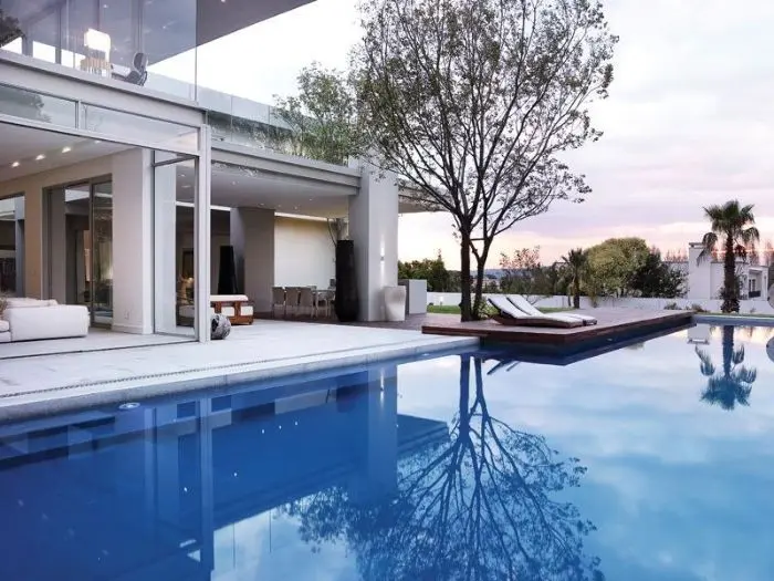 Contemporary backyard swimming pool with clean water and surrounding patio area.