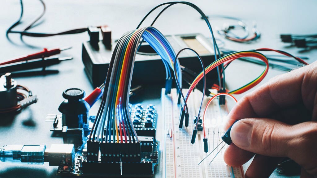 Electrical engineers designing and inspecting wiring, lighting, and power systems at a construction site.
