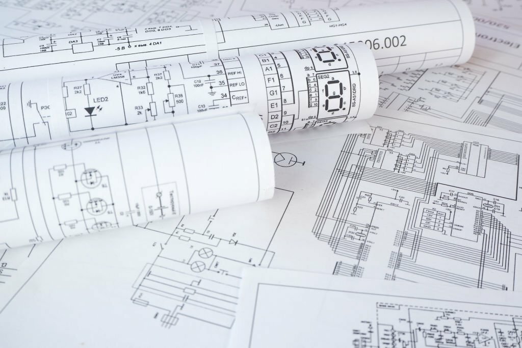 Electrical engineers designing and inspecting wiring, lighting, and power systems at a construction site.