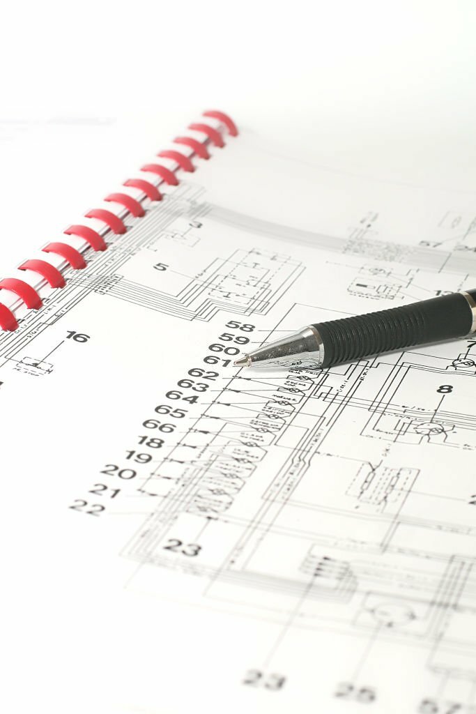 Electrical engineers designing and inspecting wiring, lighting, and power systems at a construction site.