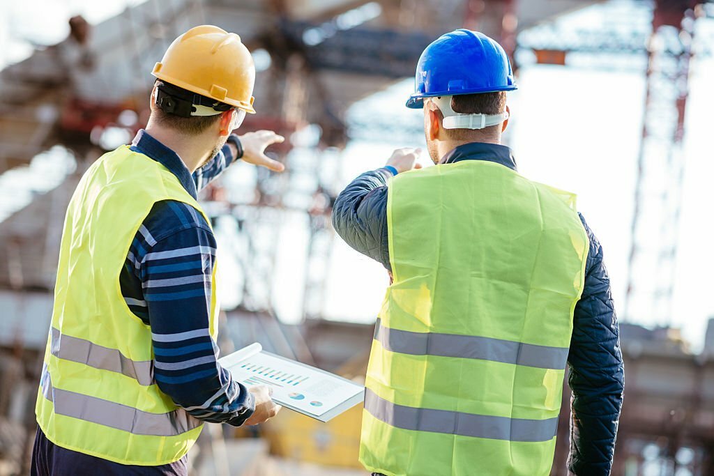 Consultants reviewing building systems and managing facilities operations for optimized performance.